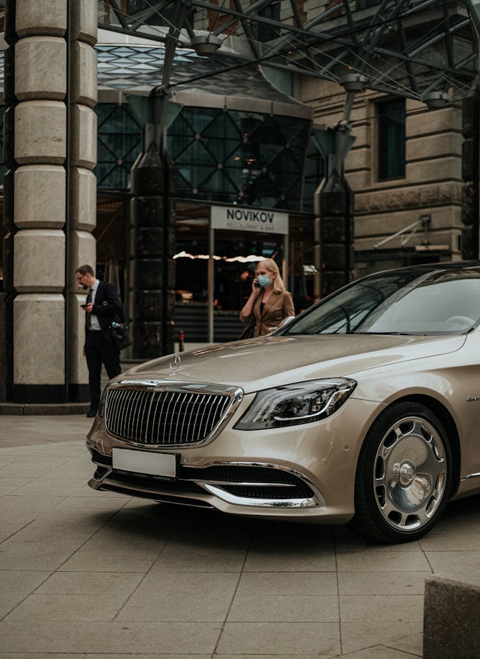 A luxury Mercedes Benz parked outdoors in Moscow with people in the background, urban lifestyle shot.